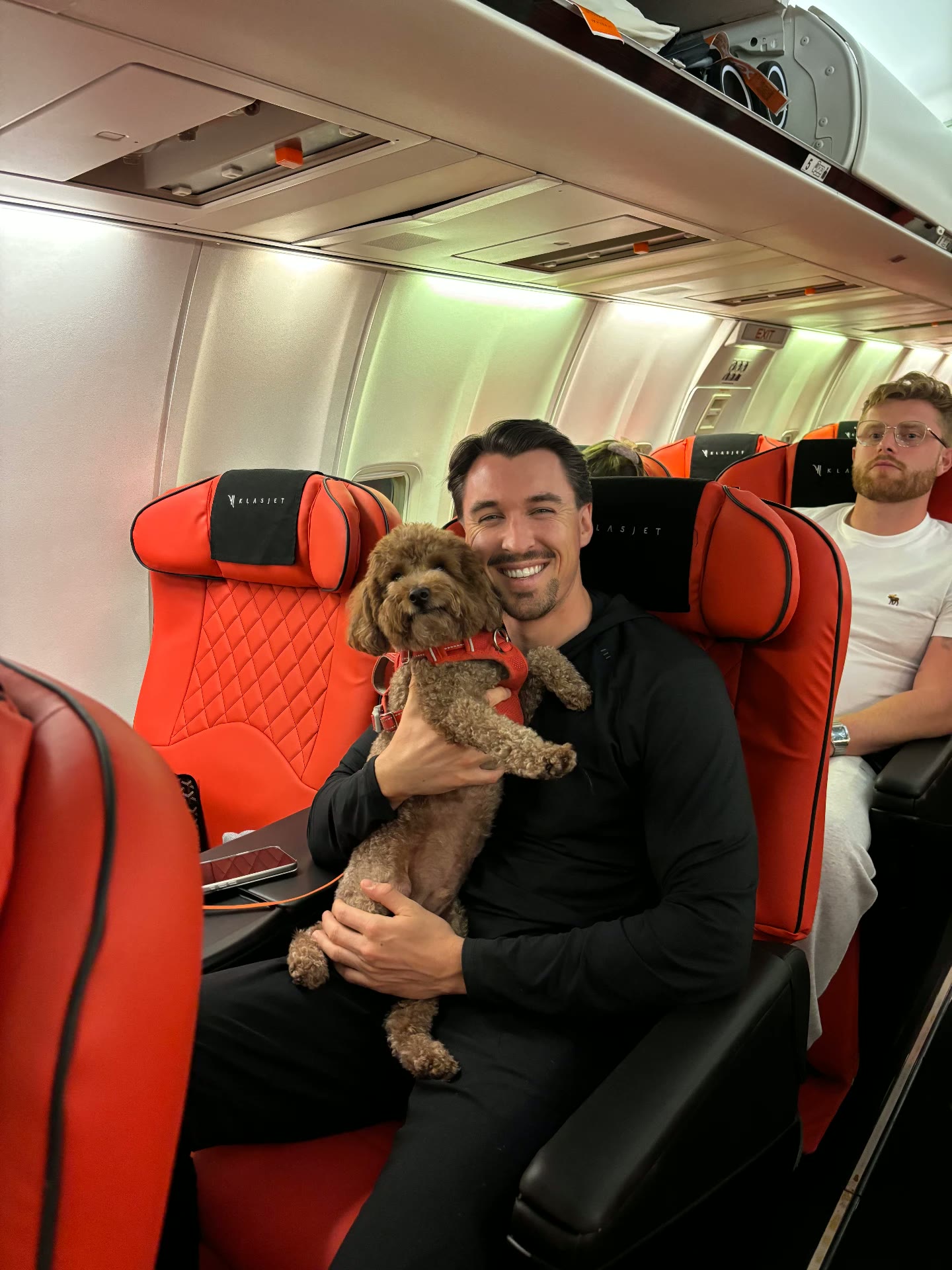 Passenger smiling with his cavapoo