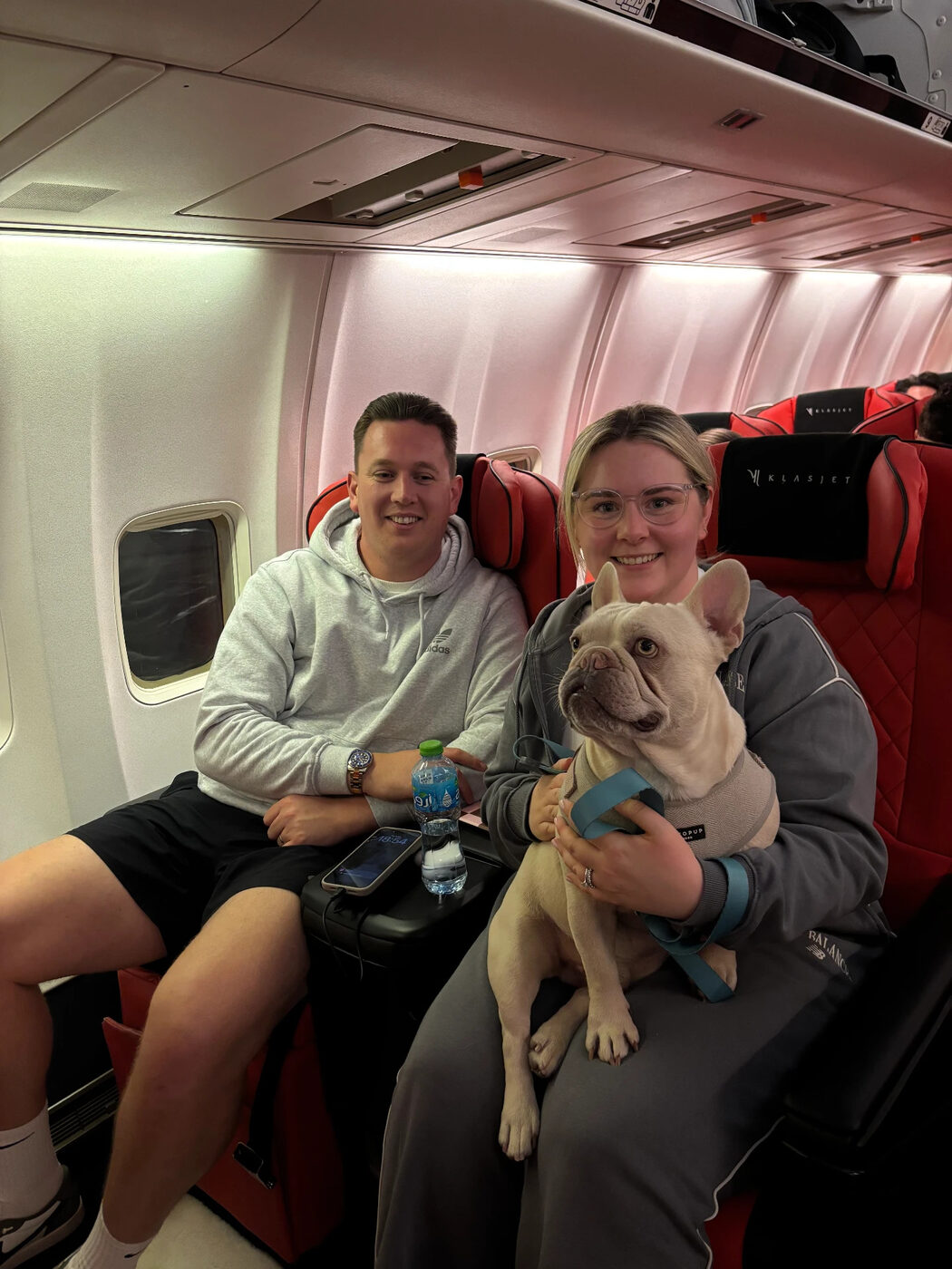 Couple onboard with their French bulldog in the cabin